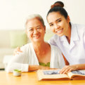 caregiver and old lady smiling